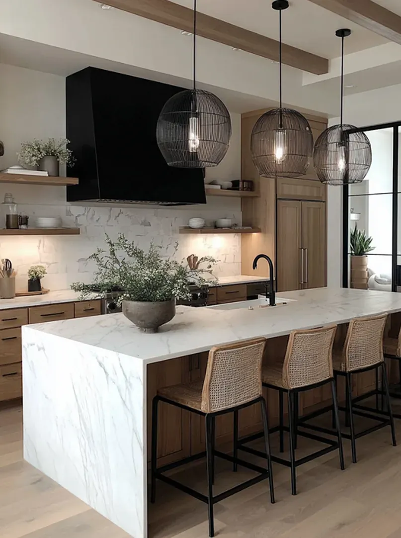 Dark cabinetry, soapstone counters, black hood over the range