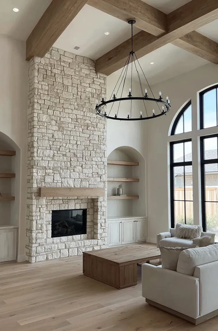 Stacked stone fireplace, exposed beams, arched built-ins